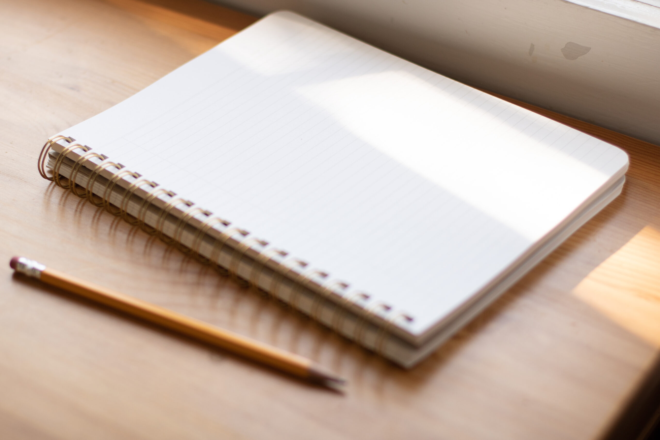 Image of a notebook and pen on a table